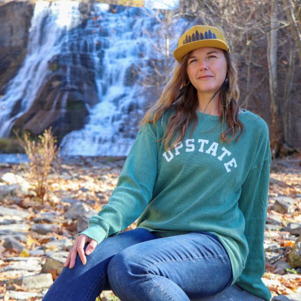 Upstate sweatshirt model shot in front of a waterfall